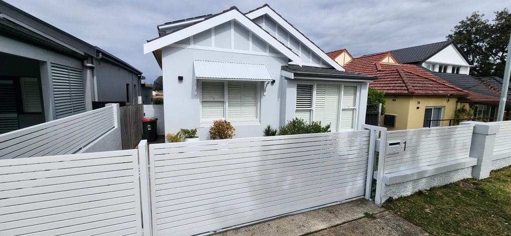 Colourise Painting residential painters completing an exterior house painting project for a white Sydney home with front fencing.