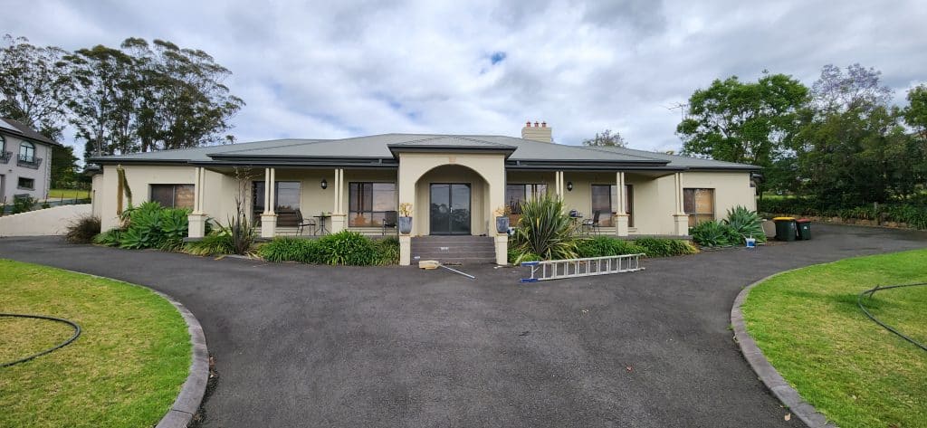 Large residential home exterior painting project in Sydney by Colourise Painting, featuring professionally painted walls, trims, columns and front entrance.